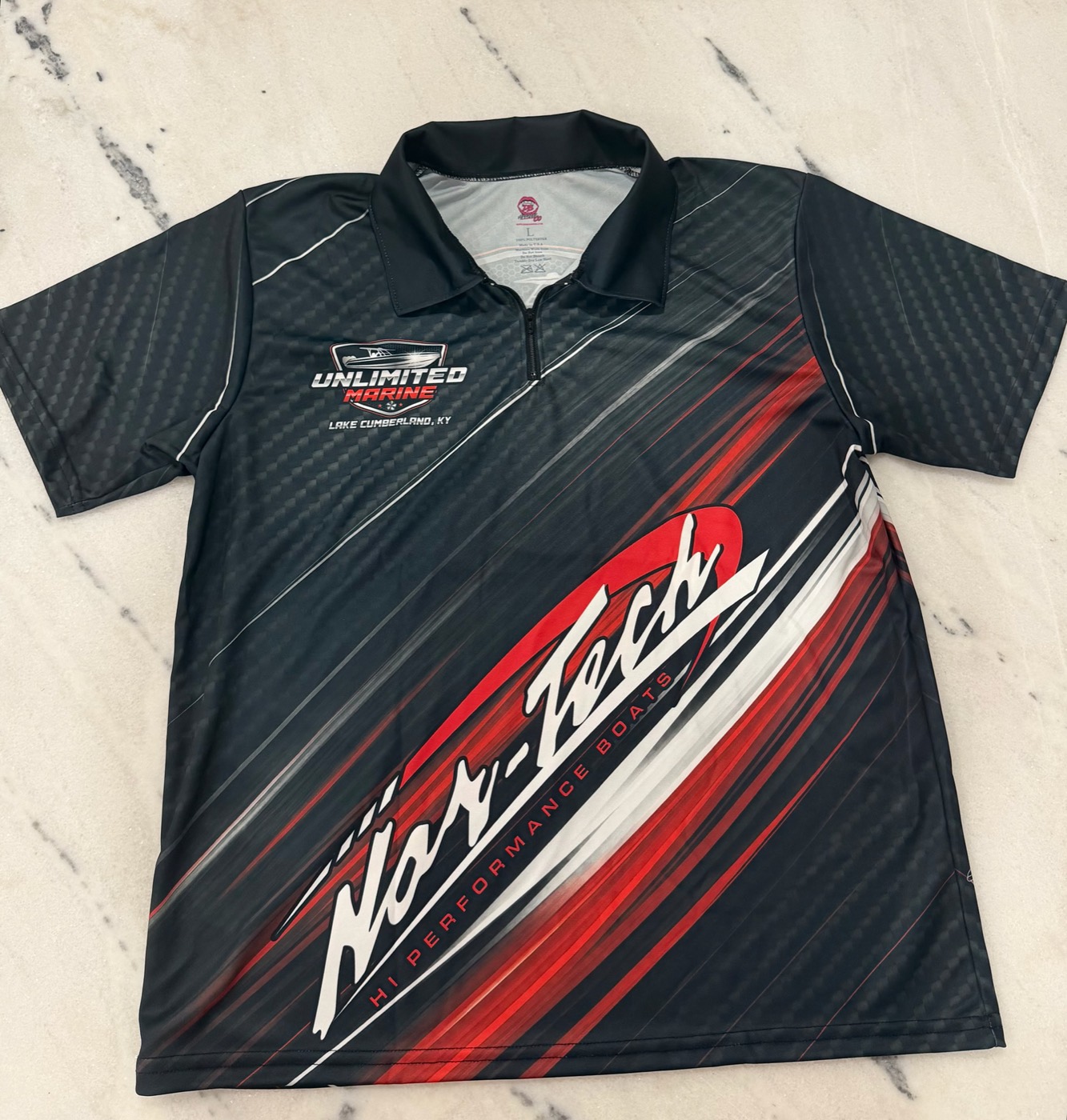 Unlimited Marine and Nor-Tech zip polo in black with red and white sublimated artwork