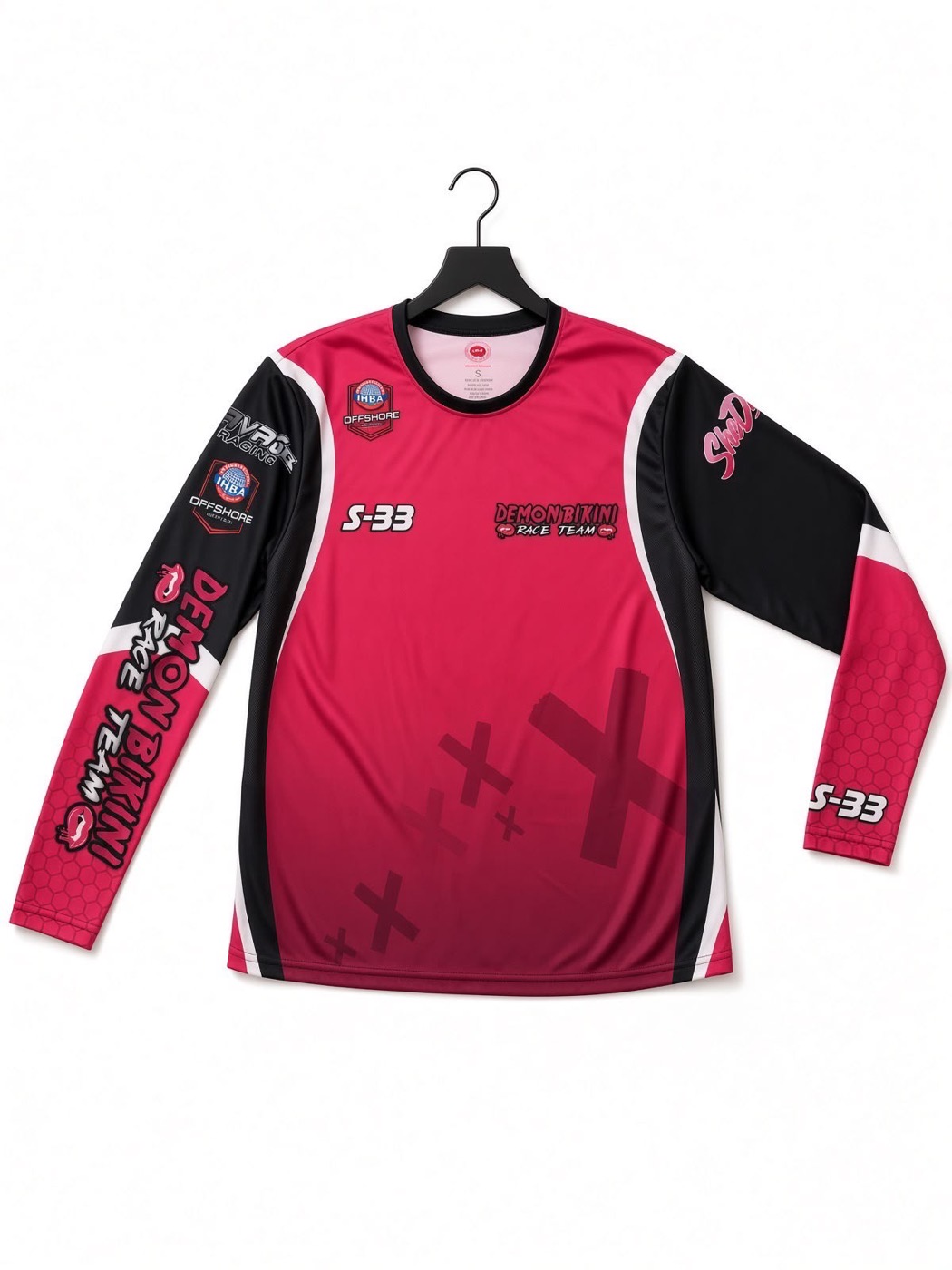 Demon Bikini Race Team S-33 long sleeve shirt in pink, black and white on a hanger
